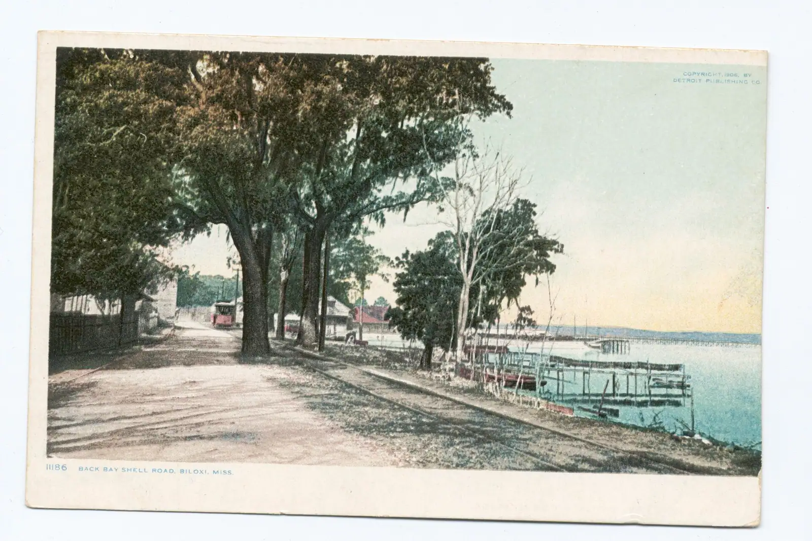 A floating dock on a sheltered bayou with flat water stretching to a low far shore