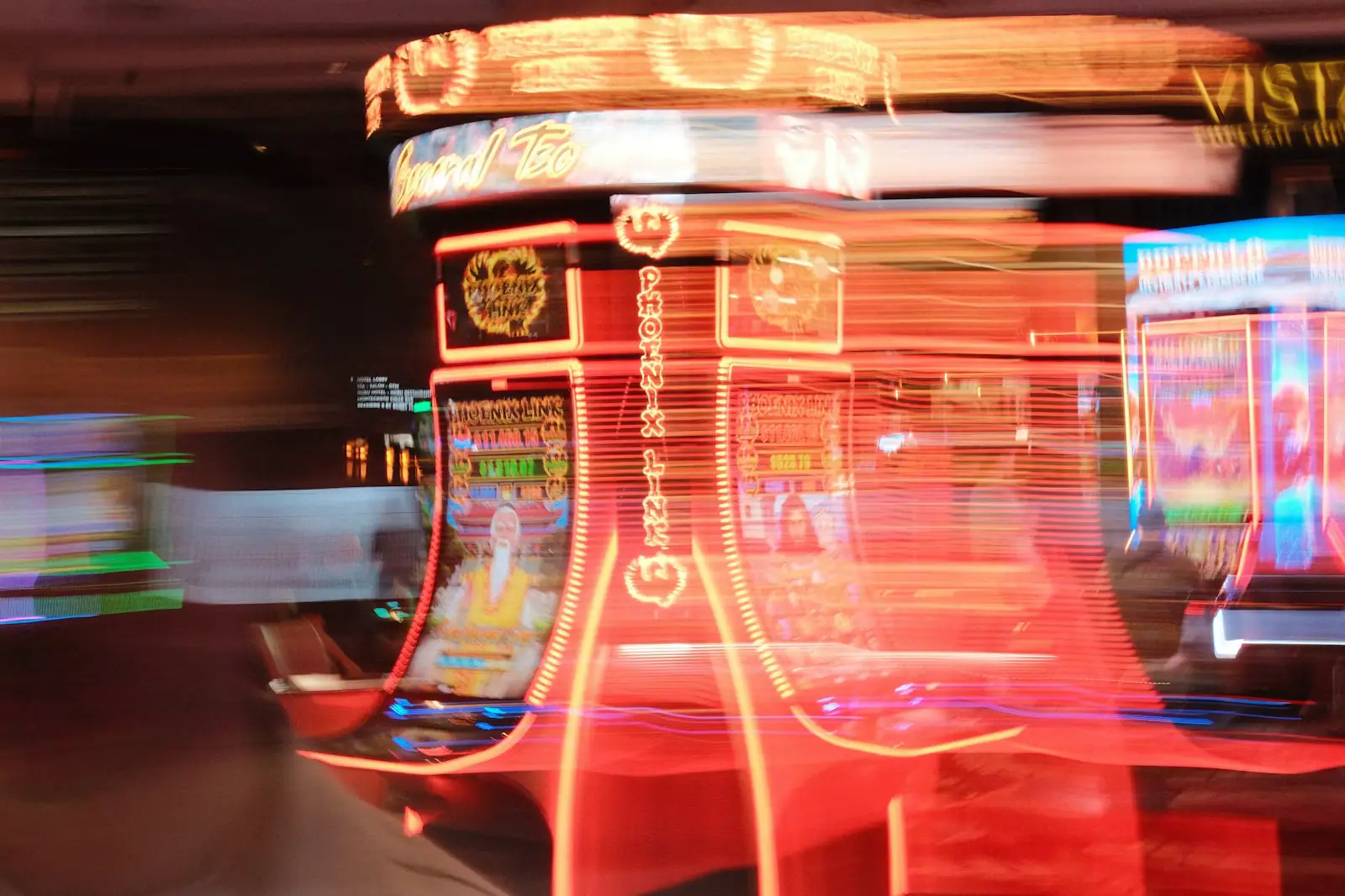 A motion-blurred casino floor with rows of lit slot machines